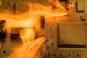 Circuit board engulfed in flames, illustrating electronic failure or overheating.