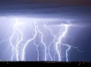 A spectacular display of multiple lightning strikes illuminating the night sky.