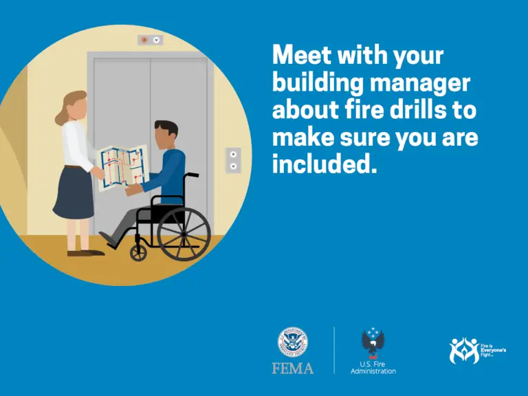 A woman stands at the open door to an office, where a man with disabilities in a wheelchair is holding a fire evacuation plan, highlighting the importance of inclusive emergency preparedness.