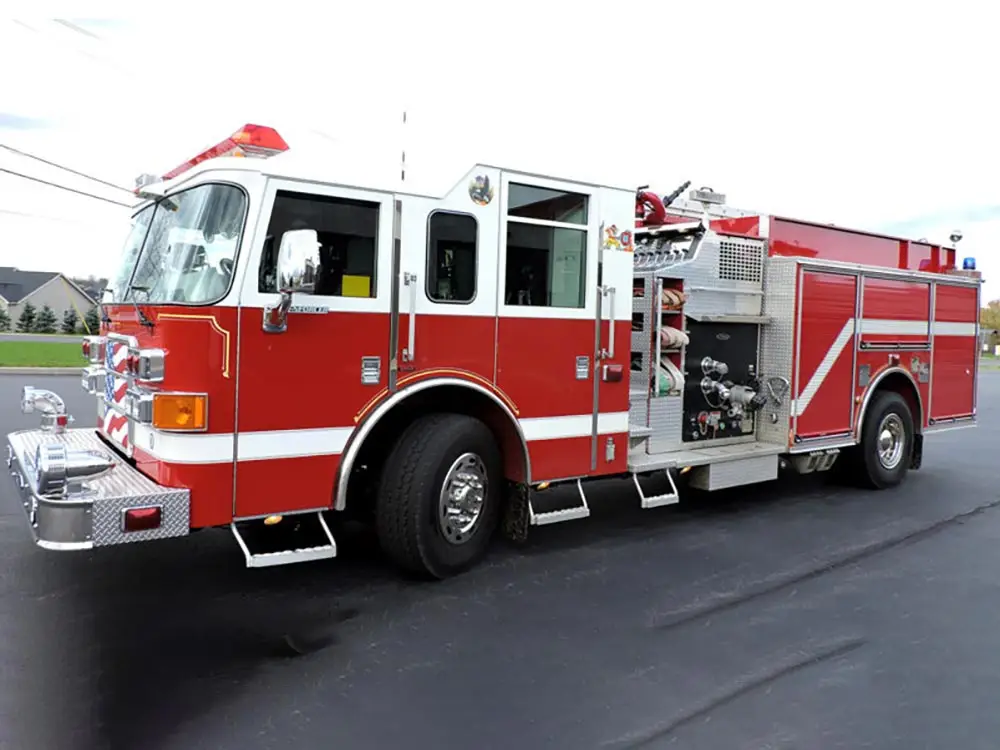 A red fire engine equipped with hoses and emergency firefighting equipment, ready for rapid response.