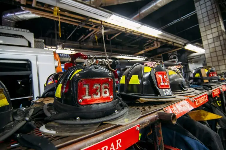 Firefighter helmets and equipment neatly arranged and ready for action at a fire station.