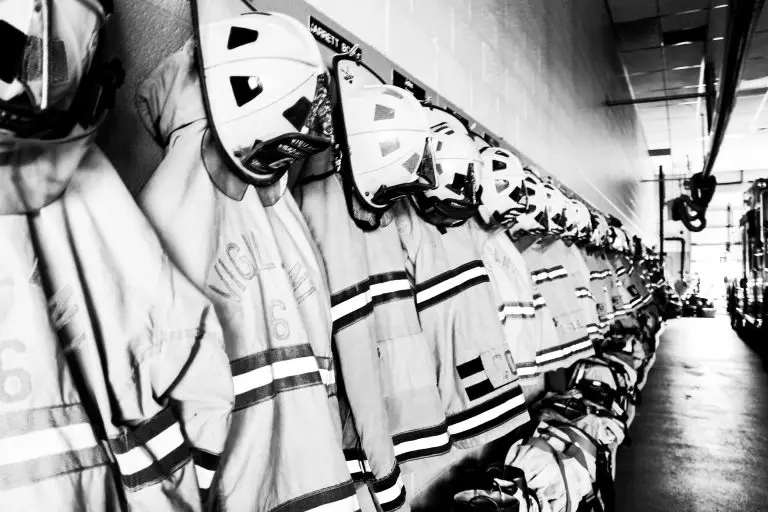 A row of firefighter gear lined up and ready for action, symbolizing preparedness and bravery.